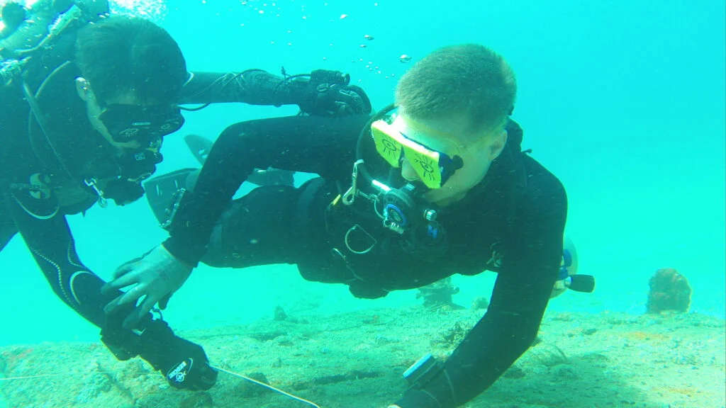 Advanced wreck divers practice no-visibility drills during training